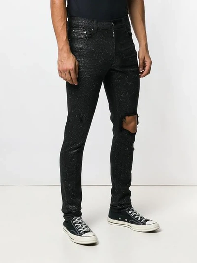 Shop Amiri Ripped Knee Glitter Jeans In Black