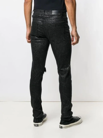 Shop Amiri Ripped Knee Glitter Jeans In Black