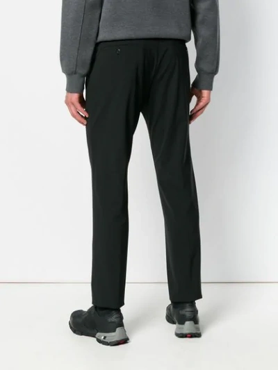 Shop Prada Stretch Slim-fit Trousers In Black