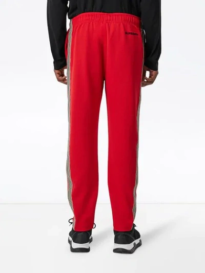 Shop Burberry Icon Stripe Detail Jersey Trackpants In Red