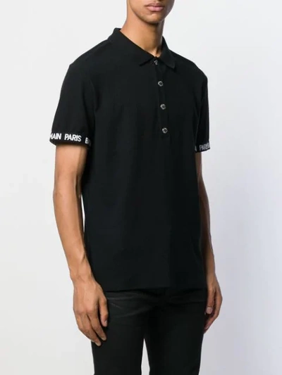 Shop Balmain Lettering Logo Polo Shirt In Black