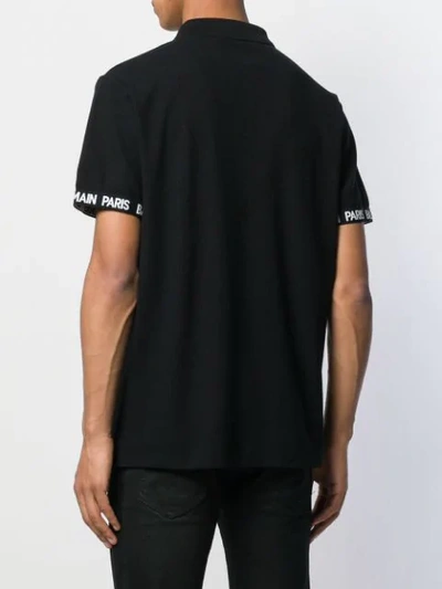 Shop Balmain Lettering Logo Polo Shirt In Black