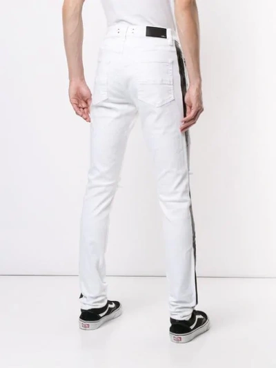 Shop Amiri Ripped Skinny Jeans - White