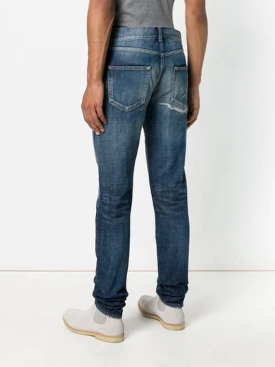 Shop Saint Laurent Faded Detail Jeans In Blue