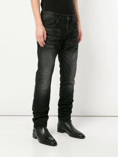 Shop Saint Laurent Low-waisted Jeans - Black