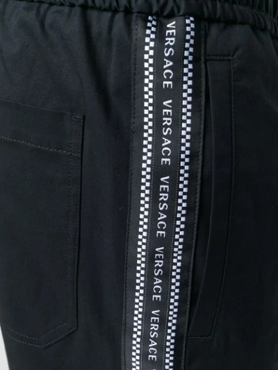 Shop Versace Relaxed Fit Track Pants In Black