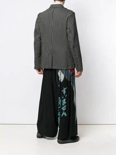 Shop Yohji Yamamoto Face Print Wide Leg Trousers In Black