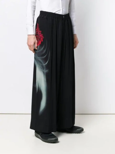 Shop Yohji Yamamoto Face Print Wide Leg Trousers In Black