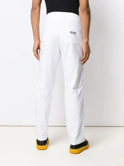 Shop Moschino Logo Track Pants In White