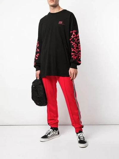 Shop Amiri Side Leather Stripe Track Pants In Red