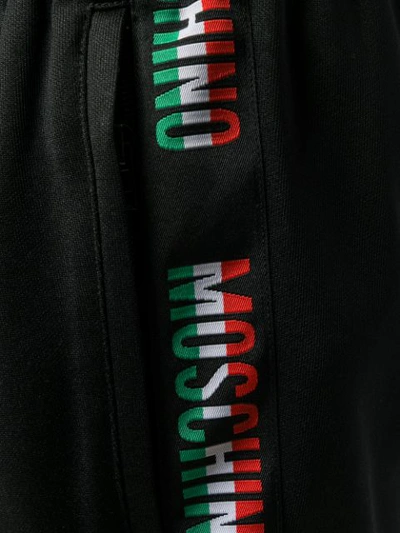 Shop Moschino Logo Embellished Track Pants - Black