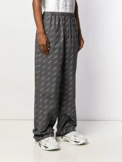 Shop Balenciaga Wide-leg Logo Print Trousers In Black