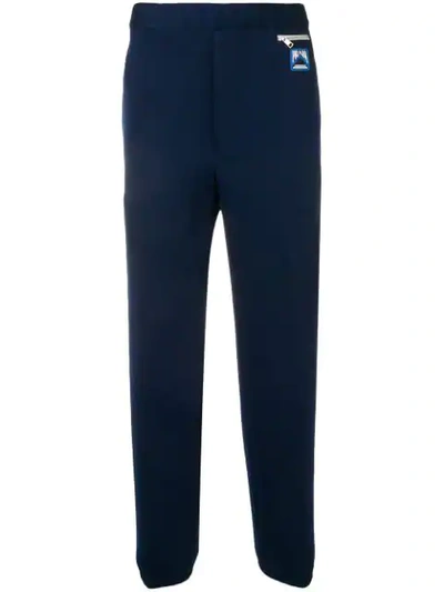 Shop Prada Logo Patch Tapered Trousers In Blue