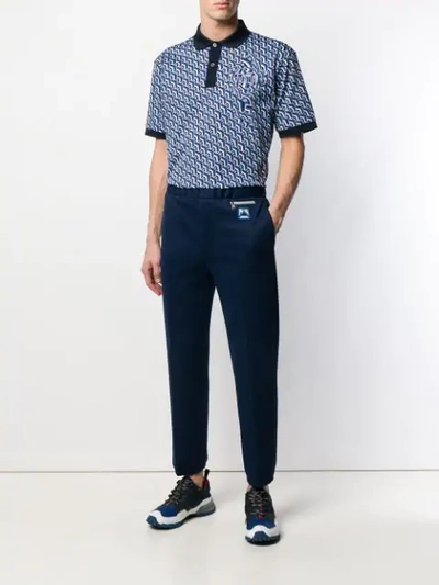 Shop Prada Logo Patch Tapered Trousers In Blue