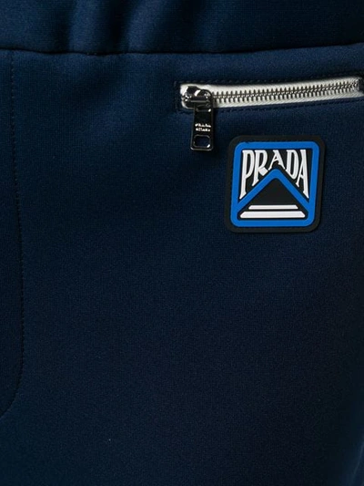 Shop Prada Logo Patch Tapered Trousers In Blue