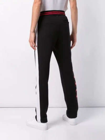 Shop Amiri Side Stripe Track Pants In Black