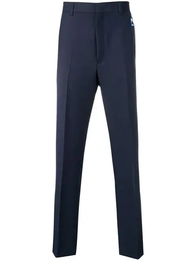 Shop Prada Logo Patch Tailored Trousers In F0r60 Divisa