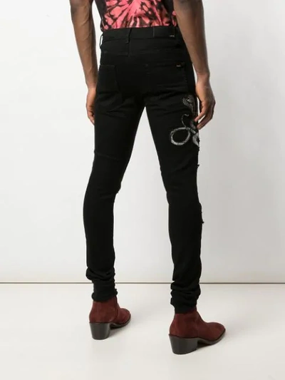 Shop Amiri Snake Patch Jeans In Black