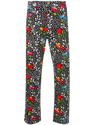 Shop Versace Floral Print Trousers In Black