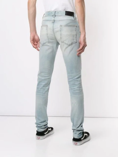 Shop Amiri Distressed Skinny Jeans In Light Indigo