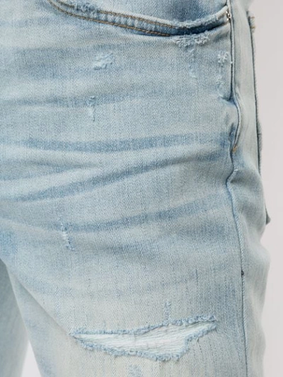 Shop Amiri Distressed Skinny Jeans In Light Indigo