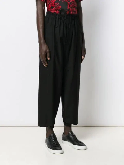 Shop Yohji Yamamoto Loose Cropped Trousers In Black