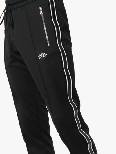 Shop Amiri Logo Embroidered Track Pants - Black