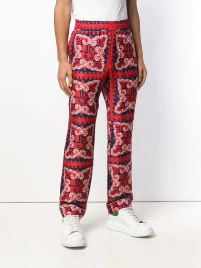 Shop Valentino Bandana Print Trousers In Red