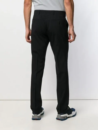 Shop Prada Pleated Tapered Trousers In Black