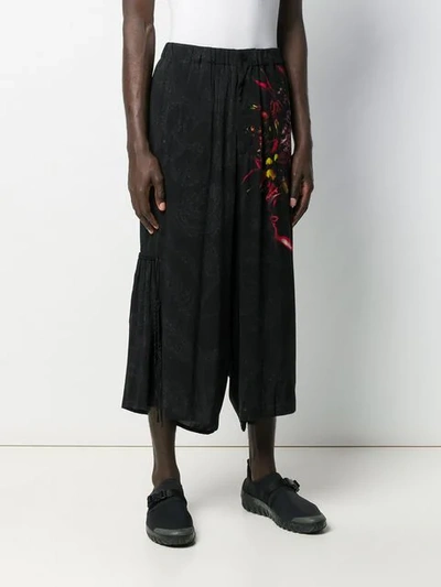 Shop Yohji Yamamoto Graphic Print Flared Trousers In Black