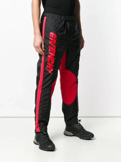 Shop Givenchy Track Style Logo Trousers In Black