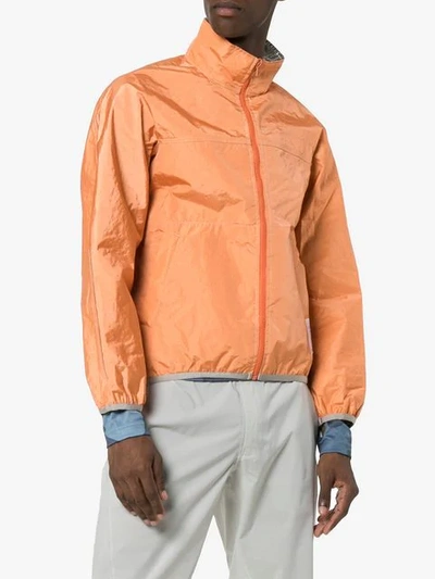 Shop Satisfy Reversible Windbreaker Jacket In Orange