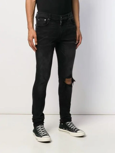 Shop Amiri Broken Skinny Jeans In Black