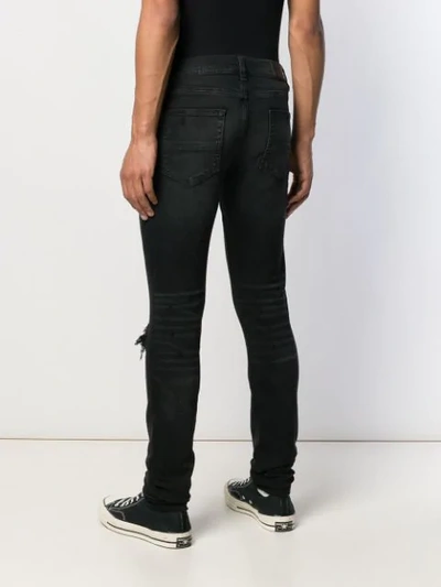 Shop Amiri Broken Skinny Jeans In Black