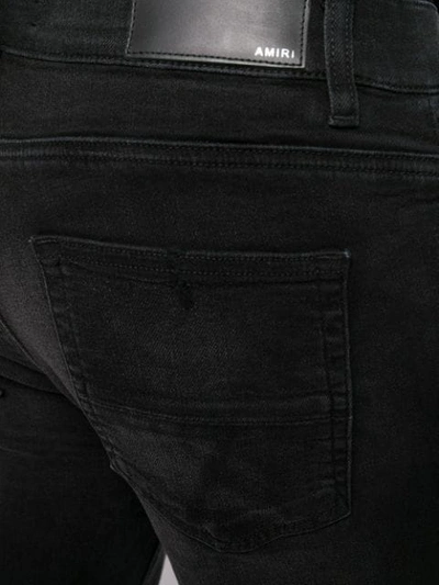 Shop Amiri Broken Skinny Jeans In Black
