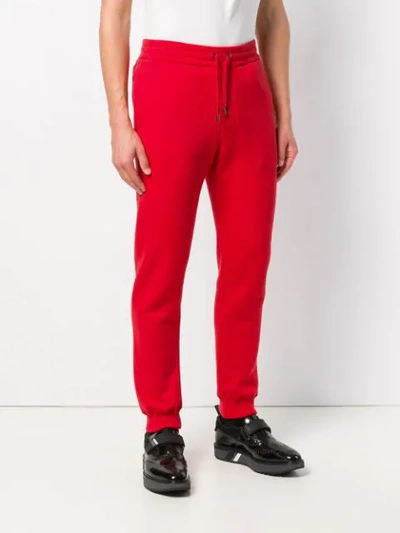 Shop Versace Tapered Joggers In Red