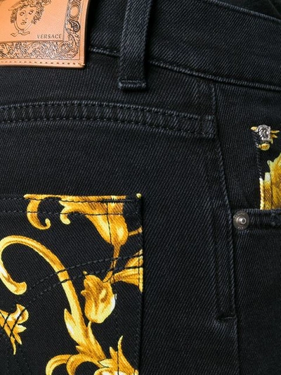 Shop Versace Baroque Print Jeans In Black