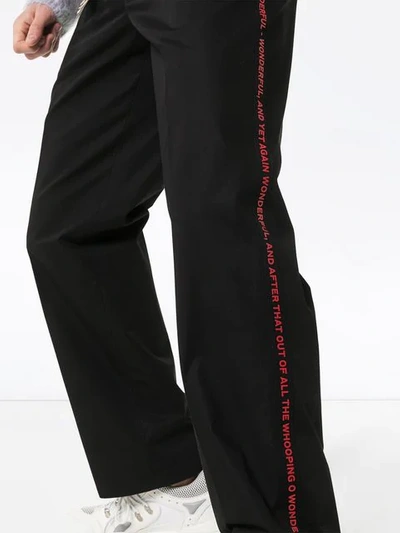 Shop Burberry Script Side Stripe Trousers In Black