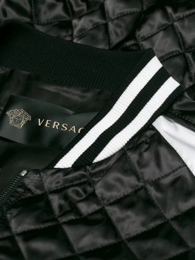 Shop Versace Satin Bomber Jacket In Black