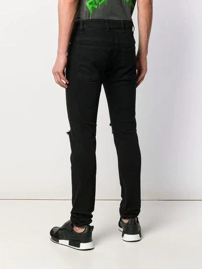 Shop Represent Ripped Skinny Jeans In Black