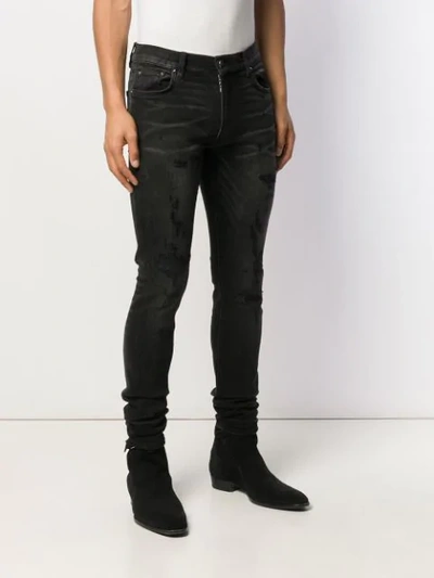 Shop Amiri Distressed Skinny Jeans - Black
