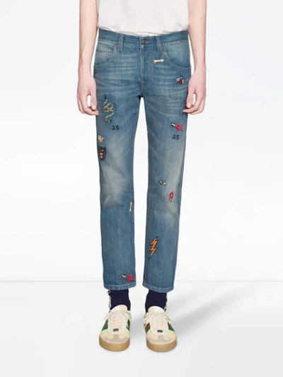 Shop Gucci Tapered Denim Pant With Symbols In Blue