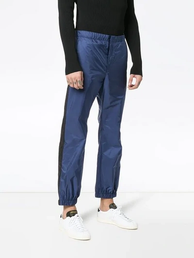 Shop Prada Logo Cuff Trousers In Baltico+nero