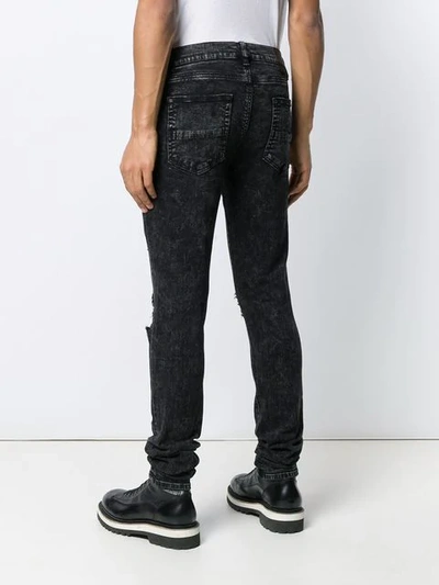 Shop Amiri Distressed Skinny Jeans In Black