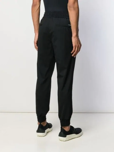 Shop Dolce & Gabbana Tapered Track Trousers In Black