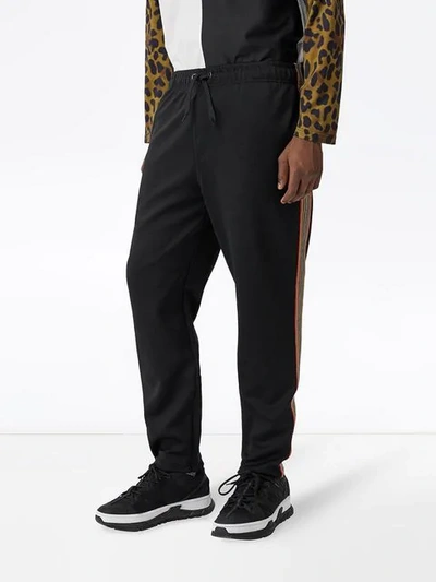 Shop Burberry Icon Stripe Detail Jersey Trackpants In Black