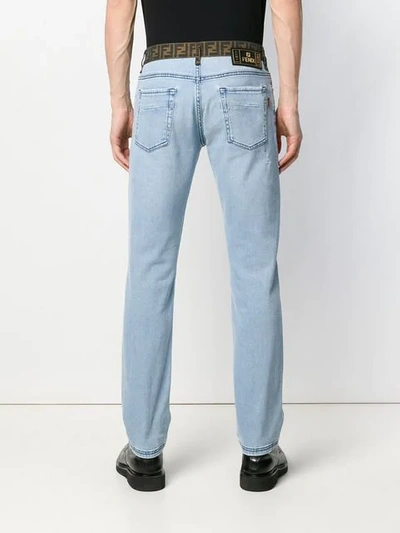 Shop Fendi Logo Banded Slim Jeans In Blue