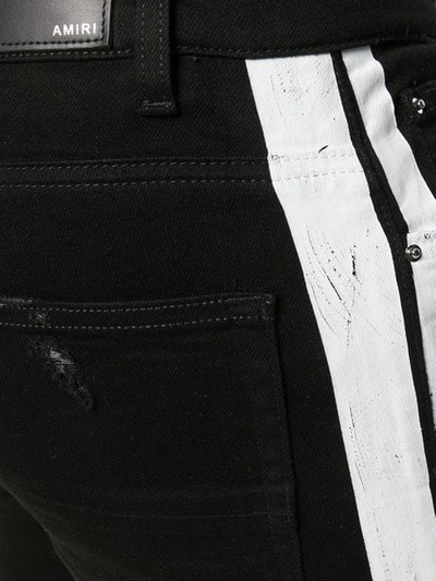 Shop Amiri Broken Track Jeans In Black