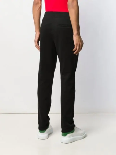 Shop Versace Heart Logo Embroidered Track Pants In Black