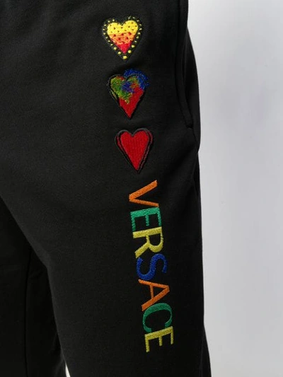 Shop Versace Heart Logo Embroidered Track Pants In Black